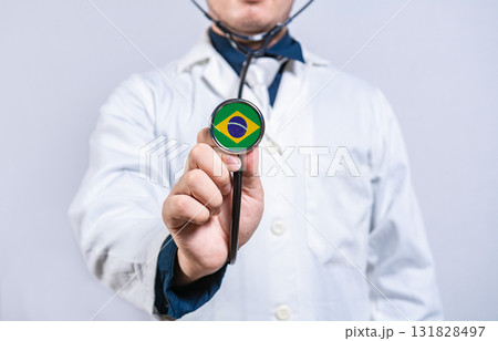 Doctor hands holding stethoscope with Brazil flag. Brazil health and care concept Doctor hands holding stethoscope with Brazil flag. Brazil health and care concept 131828497