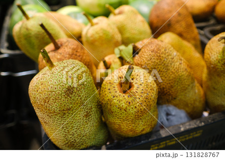 Fresh tropical fruit display featuring ripe jackfruit and varied organic produce at a local farmer's market during mid-morning hours Fresh tropical fruit display featuring ripe jackfruit and varied organic produce at a local farmer's market during mid-morning hours 131828767