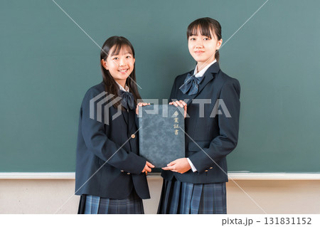 教室の黒板の前で卒業証書を持つ高校生・女子高生（卒業生・卒業式・卒業） 131831152