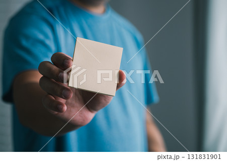 Creative hand with blank note indoor setting visual content simplistic view conceptual clarity Creative hand with blank note indoor setting visual content simplistic view conceptual clarity 131831901