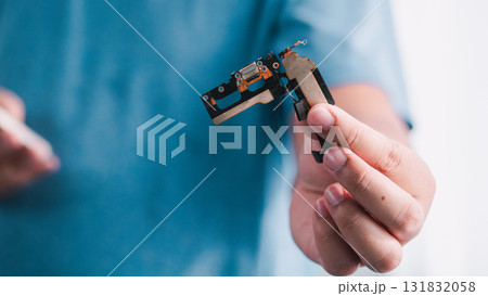 Hand-held precision tool demonstration industrial setting technical content close-up view innovative concept Hand-held precision tool demonstration industrial setting technical content close-up view innovative concept 131832058