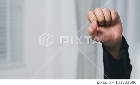 Empowering gesture a raised fist a modern office space symbolizing strength and solidarity 131832080