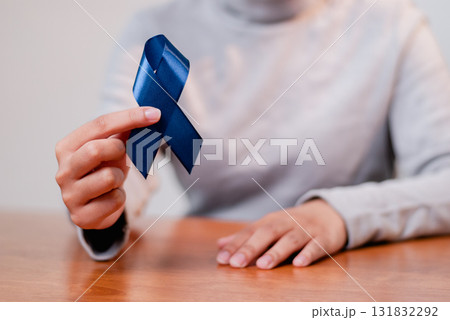 Awareness campaign blue ribbon significance community center indoor close-up health advocacy Awareness campaign blue ribbon significance community center indoor close-up health advocacy 131832292