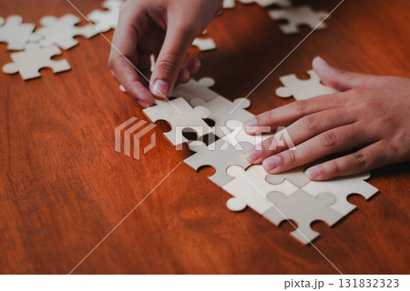 Strategic business puzzle solving creative workspace indoor close-up view collaboration concept 131832323