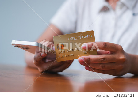 Online shopping action with credit card hand home office setting financial transaction personal perspective 131832421