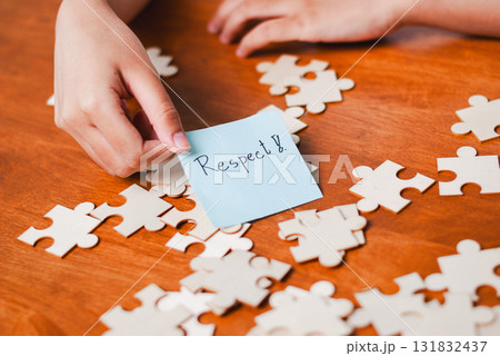 Promoting respect through puzzle pieces educational setting conceptual image warm atmosphere close-up focus Promoting respect through puzzle pieces educational setting conceptual image warm atmosphere close-up focus 131832437