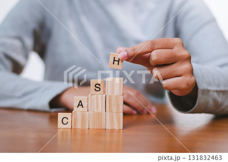 Financial literacy building cash blocks at a home office instructional content indoor close-up view Financial literacy building cash blocks at a home office instructional content indoor close-up view 131832463
