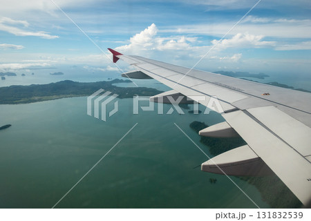 Airplane wing over scenic islands aerial view nature vibrant skies travel experience Airplane wing over scenic islands aerial view nature vibrant skies travel experience 131832539
