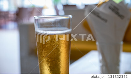 Refreshing beer served in a glass bar setting beverage indoor ambience close-up view Refreshing beer served in a glass bar setting beverage indoor ambience close-up view 131832551