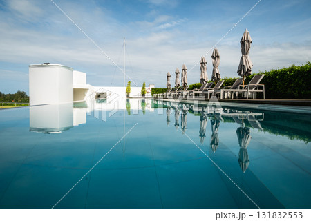 Relaxing poolside retreat luxurious resort tranquil setting aerial view serenity Relaxing poolside retreat luxurious resort tranquil setting aerial view serenity 131832553
