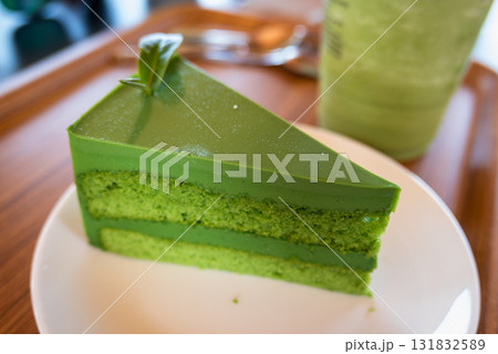 Indulge in a vibrant green matcha cake slice cozy  setting culinary delight close-up experience 131832589