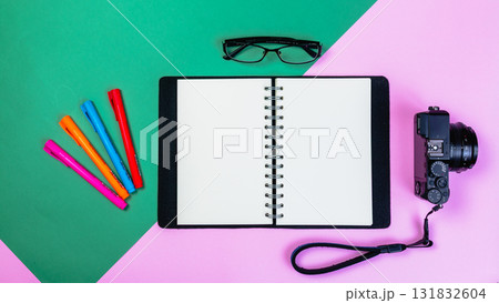 Creative setup with camera notepad and colorful props vibrant background Creative setup with camera notepad and colorful props vibrant background 131832604