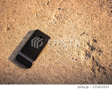 Smartphone abandoned sandy beach coastal scene outdoor natural light Smartphone abandoned sandy beach coastal scene outdoor natural light 131832635