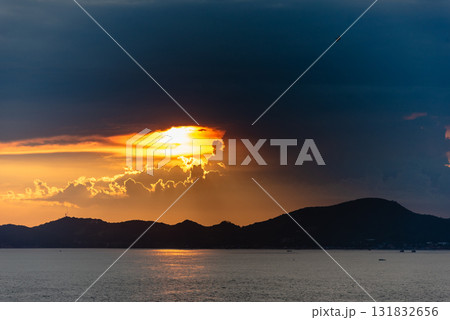 Dramatic sunset over mountain landscape ocean view serene nature scene tranquil evening 131832656