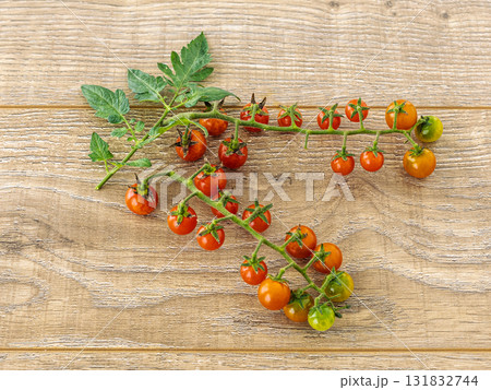 Just picked fresh cherry tomatoes on the wooden background. 131832744