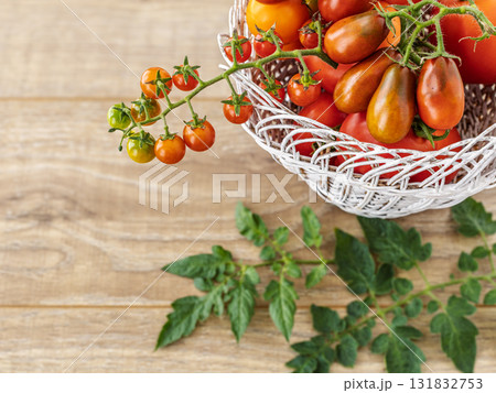 Just picked fresh tomatoes in the wicker basket. 131832753
