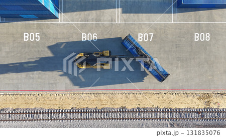 Loading containers using an industrial crane. A logistics company engaged in import and export. The concept combines industry and transport. Loading containers using an industrial crane. A logistics company engaged in import and export. The concept combines industry and transport. 131835076