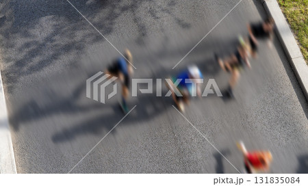 Marathon runners running down the street in a top view, the concept of good physical fitness and readiness for long-distance races. Marathon is a great way to challenge yourself and test your strength 131835084