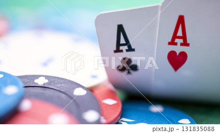 A poker player has two aces on the table. They have opened their cards and seen that they have two aces. This is a strong hand and it would be wise for them to continue playing and raise the stakes. A poker player has two aces on the table. They have opened their cards and seen that they have two aces. This is a strong hand and it would be wise for them to continue playing and raise the stakes. 131835088