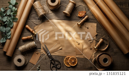Artisan Christmas Gift Wrapping Workshop Station with Kraft Paper Rolls Natural Twine Vintage Scissors and Eucalyptus Sprigs on Reclaimed Barn Wood Surface Artisan Christmas Gift Wrapping Workshop Station with Kraft Paper Rolls Natural Twine Vintage Scissors and Eucalyptus Sprigs on Reclaimed Barn Wood Surface 131835121