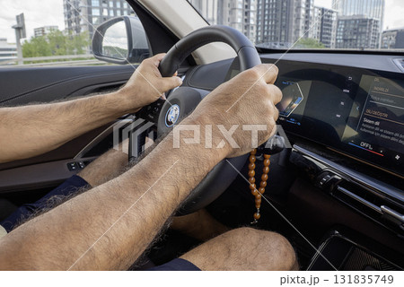 Mens hands on the streering wheel of the car 131835749