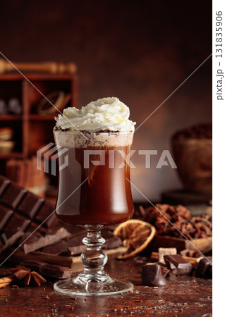 Hot chocolate with whipped cream in a glass mug. Hot chocolate with whipped cream in a glass mug. 131835906