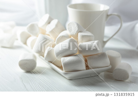 Marshmallows on a wooden table. 131835915
