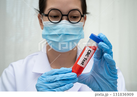 Scientist medical professional holding Cholesterol CBC test tube blood for research in science laboratory. 131836909