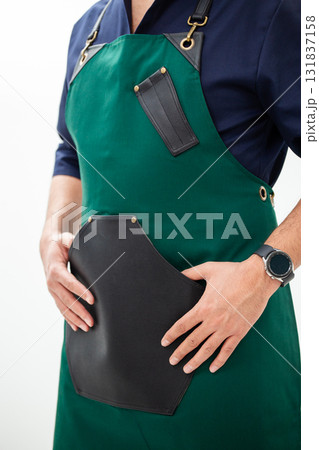 Man in green apron with leather pocket - style, practicality and professional look 131837158