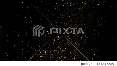 Detailed wave of airborne clay dust swirling in chaotic motion, captured in freeze  motion. Dramatic natural explosion of earthy particles on black background. 131837289