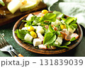 Fresh arugula salad with prosciutto, melon, and olives for a delicious summer meal 131839039