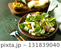 Fresh arugula salad with prosciutto, melon, and olives for a delicious summer meal. Copy space. 131839040