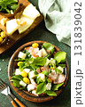 Fresh arugula salad with prosciutto, melon, and olives for a delicious summer meal. 131839042