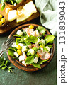 Fresh arugula salad with prosciutto, melon, and olives for a delicious summer meal. Copy space. 131839043