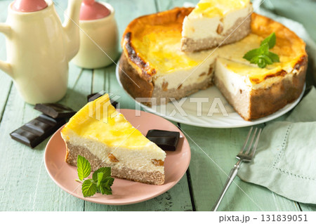 Delicious lemon cheesecake with tea set for dessert presentation. Delicious lemon cheesecake with tea set for dessert presentation. 131839051