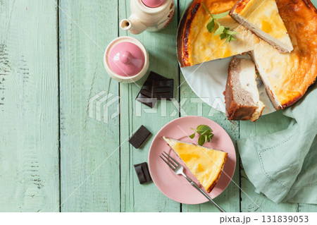 Delicious lemon cheesecake with tea set for dessert presentation. Top view flat lay background. Copy space. 131839053