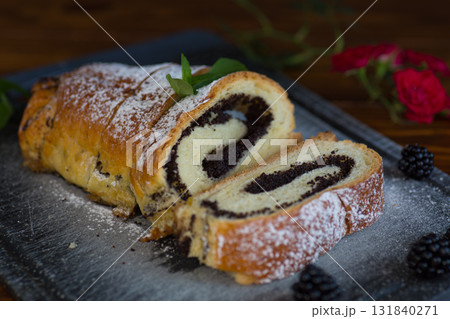 Homemade poppy seed roll with powdered sugar on a tray Homemade poppy seed roll with powdered sugar on a tray 131840271
