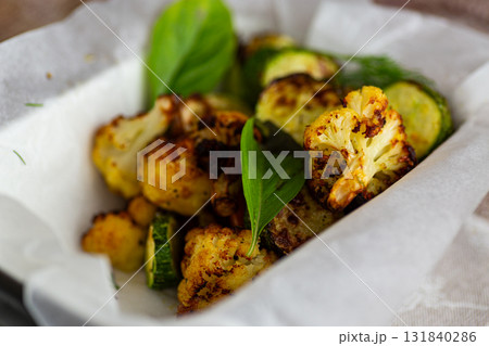 Freshly roasted zucchini and cauliflower served in baking tray Freshly roasted zucchini and cauliflower served in baking tray 131840286