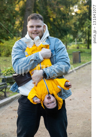 Playful Moment: Man and Baby in the Park Playful Moment: Man and Baby in the Park 131841077