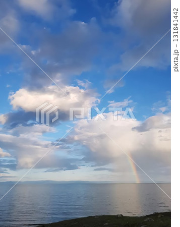 Rainbow Arching Over Lake Baikal Under Dramatic Clouds 131841442