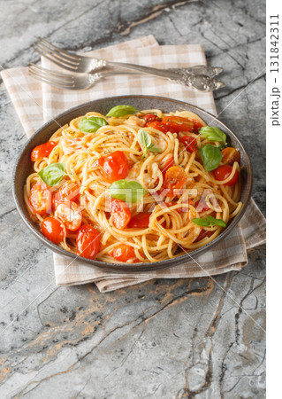 Pasta Margherita with fresh tomatoes, mozzarella cheese, basil and olive oil close-up in a plate. Vertical Pasta Margherita with fresh tomatoes, mozzarella cheese, basil and olive oil close-up in a plate. Vertical 131842311