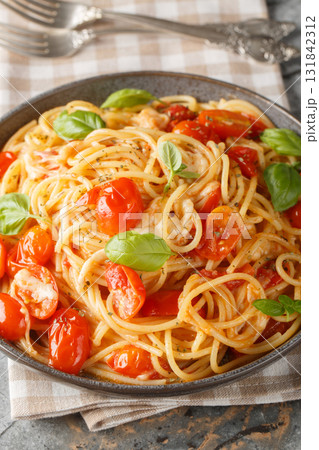 Margherita Spaghetti made with tomatoes, basil, and mozzarella closeup on the plate. Vertical Margherita Spaghetti made with tomatoes, basil, and mozzarella closeup on the plate. Vertical 131842312