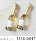 Minimalist mockup with two champagne mini bottles and blank labels on plain background. Top view. 131842947