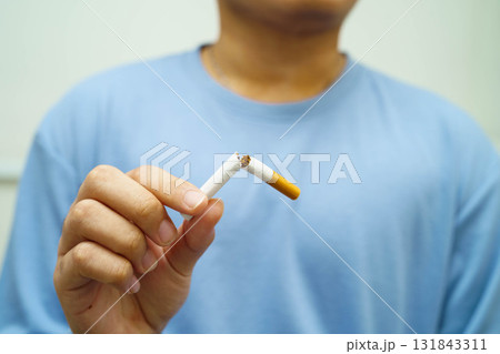 Quit smoking, Asian man breaking destroy cigarette in hand. 131843311