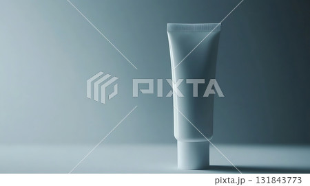 Minimalist Cosmetic Tube Standing Upright Against Blue Gradient Background Minimalist Cosmetic Tube Standing Upright Against Blue Gradient Background 131843773