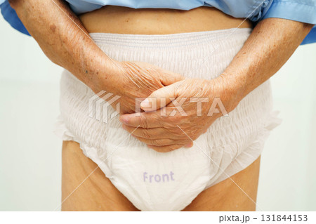 Asian senior woman patient wearing adult incontinence diaper pad in hospital. 131844153