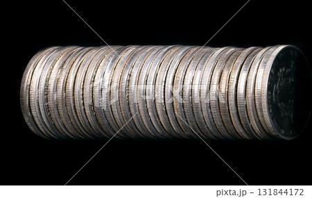 Row of silver coins, placed side by side, from above, on black background. Circulated silver bullion coins, with reeded edges, each of one troy ounce, and of 99.9 percent pure silver. Photo Row of silver coins, placed side by side, from above, on black background. Circulated silver bullion coins, with reeded edges, each of one troy ounce, and of 99.9 percent pure silver. Photo 131844172