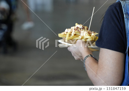 hands holding french fries plate with sauces hands holding french fries plate with sauces 131847159