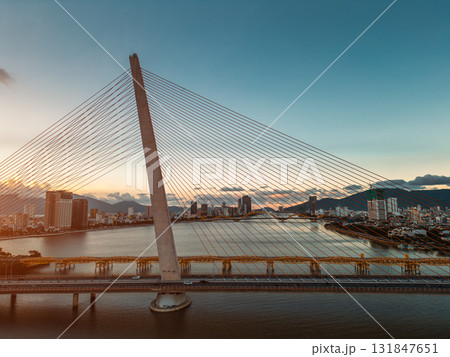 Modern cable-stayed bridge over Han River in Da Nang, Contemporary urban span connecting city skyline across Vietnamese waterway Modern cable-stayed bridge over Han River in Da Nang, Contemporary urban span connecting city skyline across Vietnamese waterway 131847651