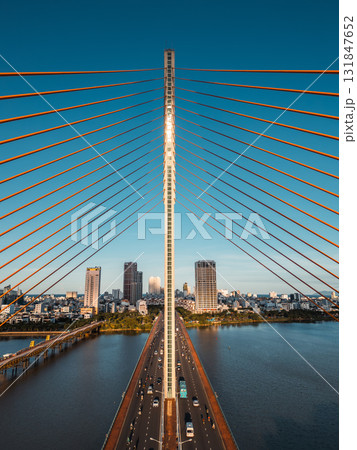 Symmetric modern cable-stayed bridge over Han River in Da Nang, Contemporary urban span connecting city skyline across Vietnamese waterway Symmetric modern cable-stayed bridge over Han River in Da Nang, Contemporary urban span connecting city skyline across Vietnamese waterway 131847652